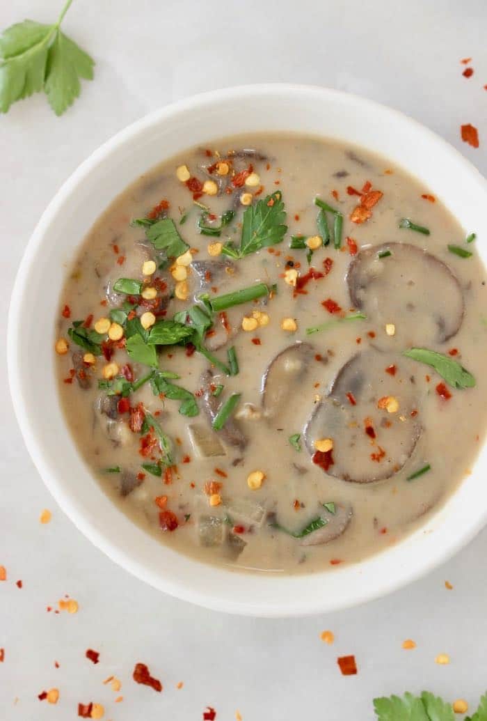 Simple vegan cream of mushroom soup recipe with silky coconut cream and loads of real sliced up baby bella mushrooms. I can't believe it's vegan!