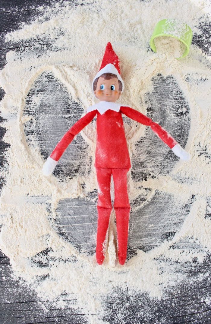 Funny Elf on the Shelf Making Snow Angels with Flour