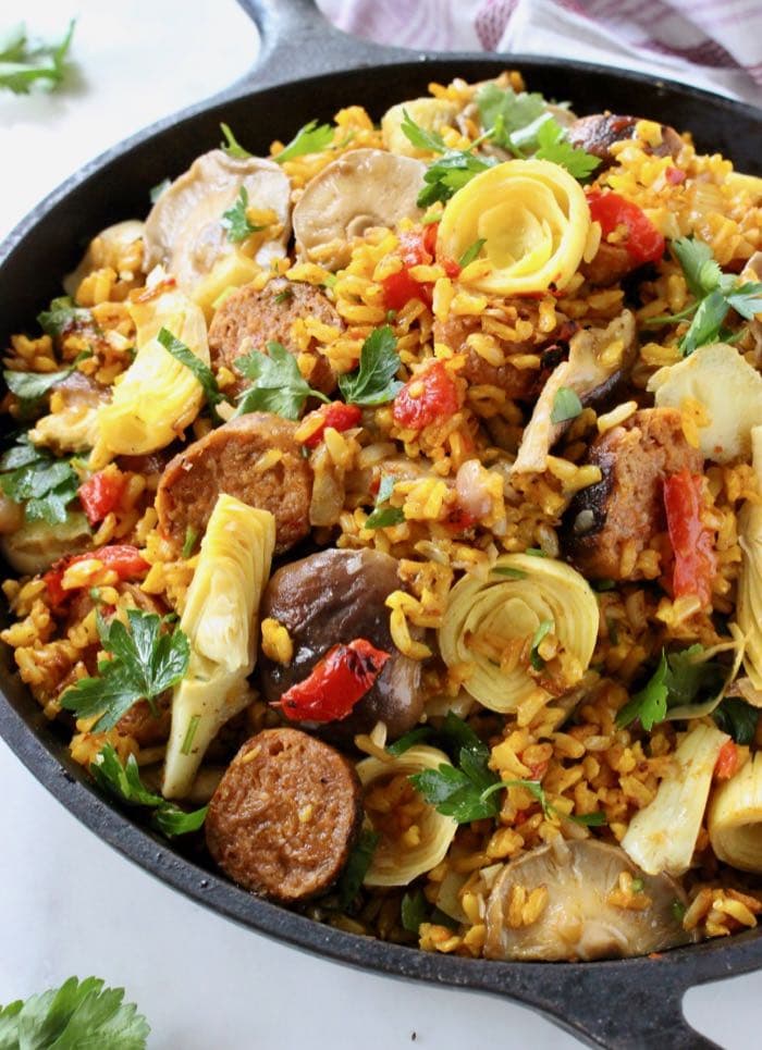 Best Vegan Paella with Brown Rice, Mushrooms, Roasted Peppers and Artichokes.
