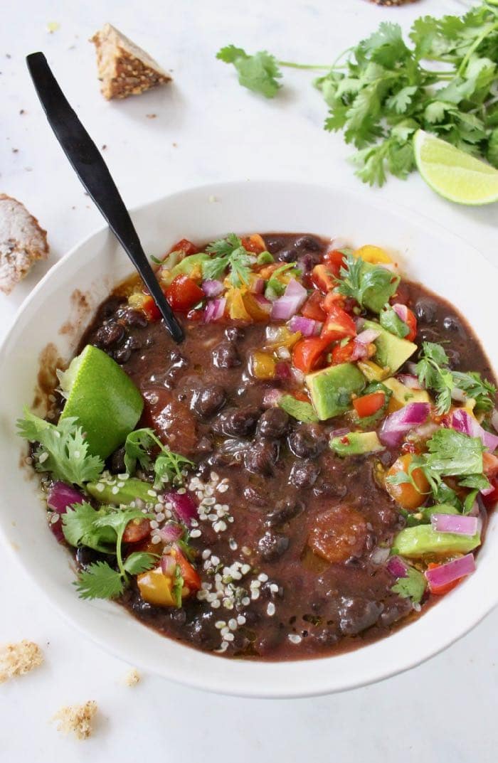 Healthy and Smoky Vegan Black Bean Soup from Scratch with Salsa and Lime.