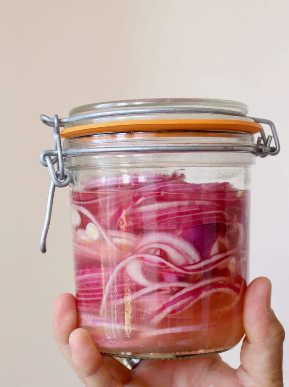 Pickled red onions in a jar.