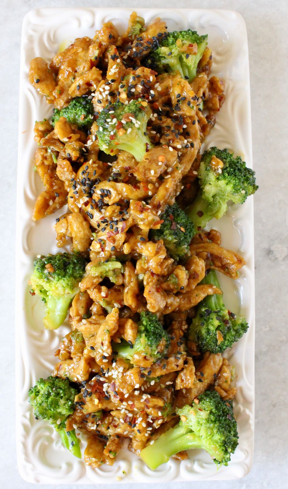Vegan chicken with broccoli in a garlic ginger sauce on serving platter.